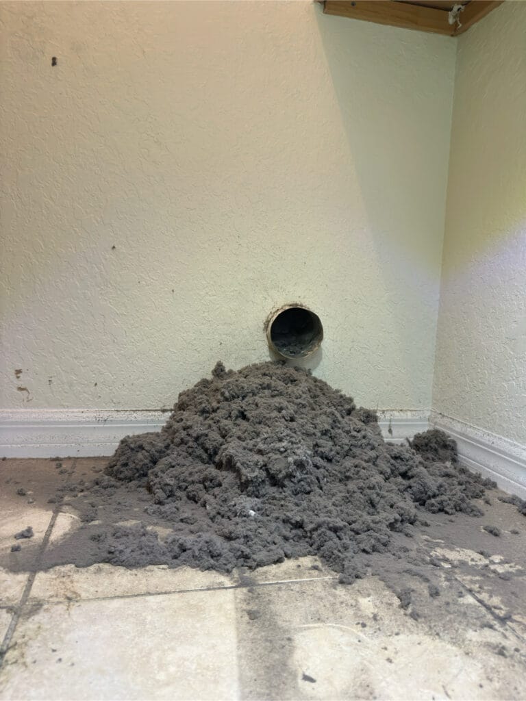 close-up of dark dryer burn residue along a lint trap opening
