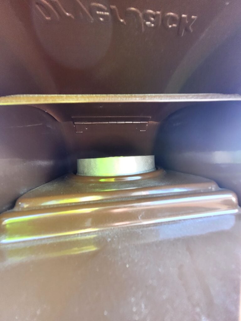 homeowner checking exterior dryer vent cap for blockage