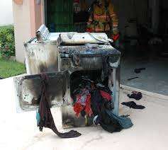 homeowner checking dryer after noticing dryer smells like it's burning