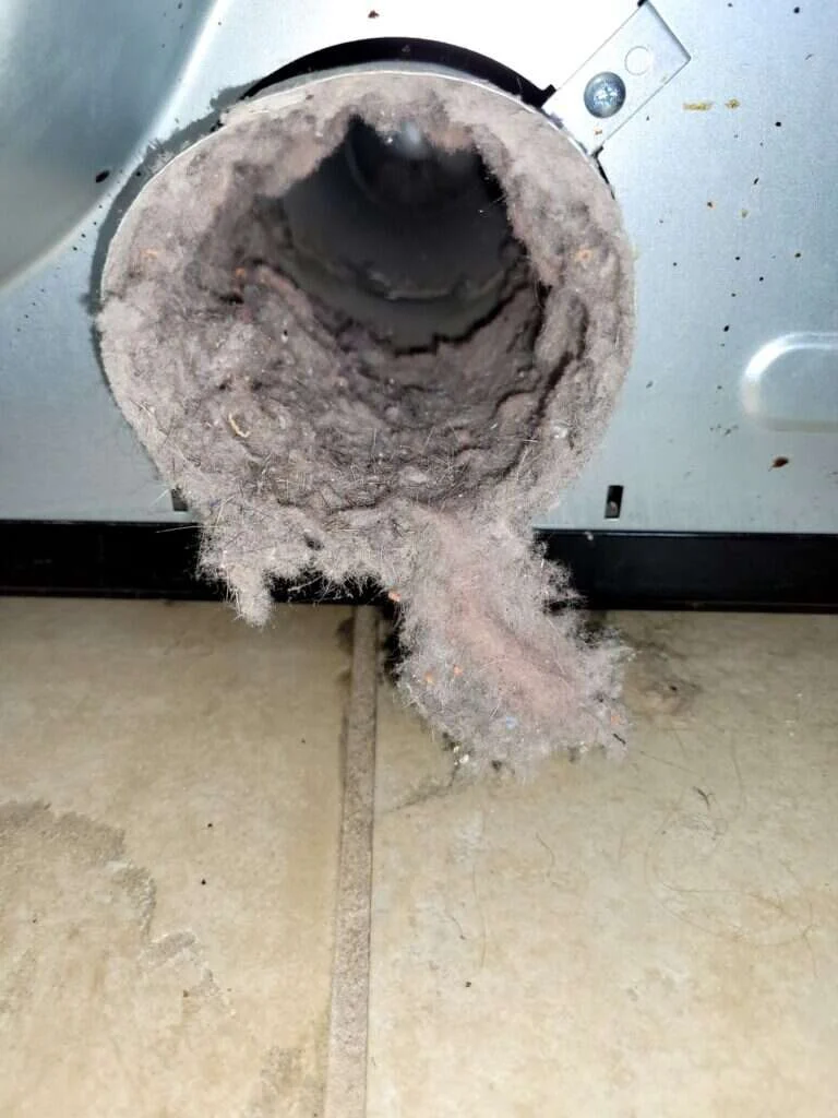 Why Your Dryer Is Smoking—And How to Stop It Safely 2 homeowner reviewing clogged duct after dryer smoking incident in Ocala FL home