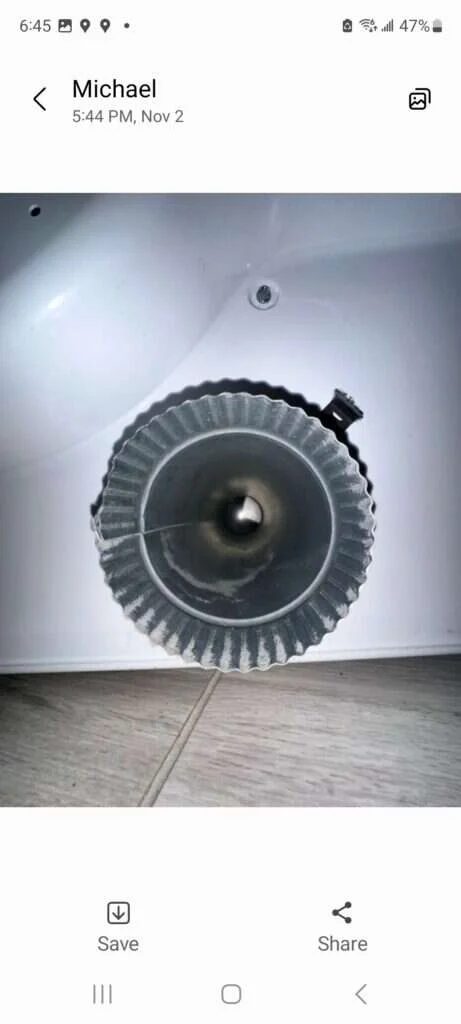 Why Your Dryer Is Smoking—And How to Stop It Safely 1 technician inspecting dryer vent duct for lint causing dryer smoking