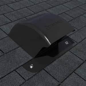 A close-up of a low-profile black DryerJack roof vent properly installed on a grey shingled roof, showing the specialized hood designed for maximum airflow.